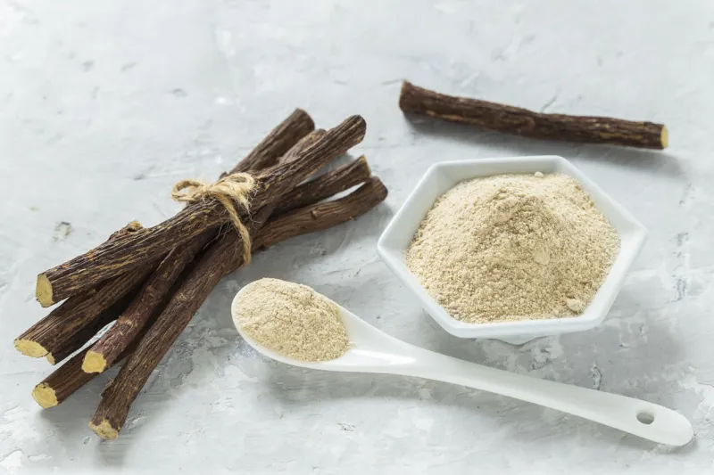 powder and licorice root on the table - glycyrrhiza glabra