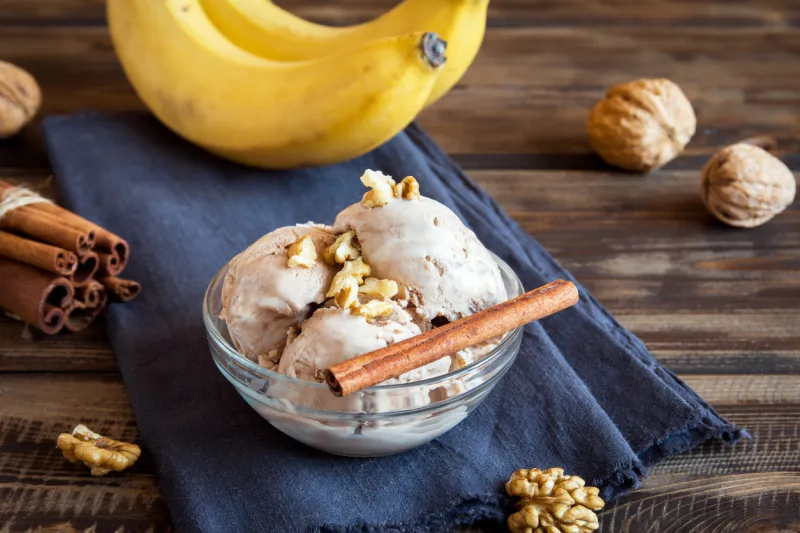 healthy raw vegan banana and cinnamon ice cream (icecream, nicecream) with walnut topping - healthy vegetarian diet vegan raw fruit organic delicious dessert, dairy free, gluten free