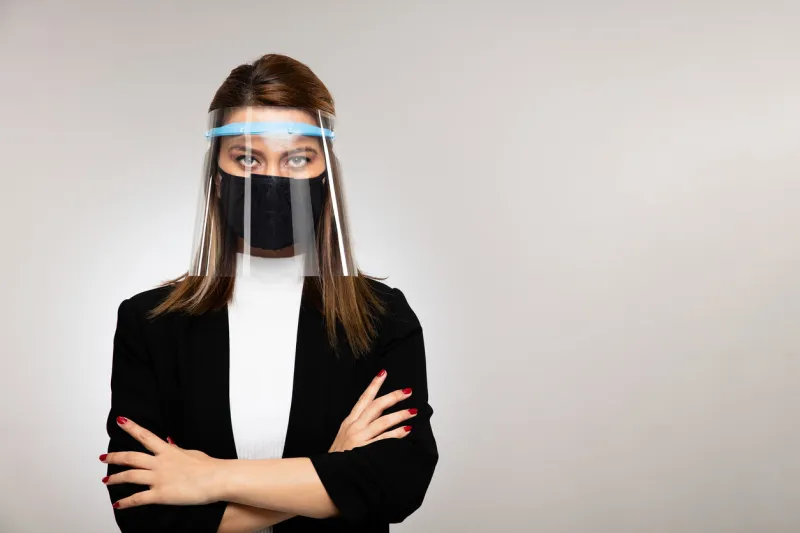 corona virus concept woman businessman posing with visor mask