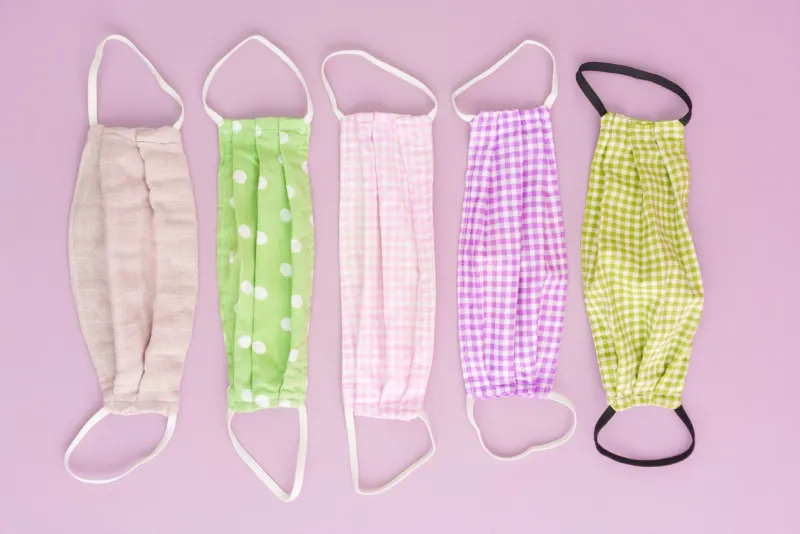 colorful diy corona covid19 fabric face mask on pink background