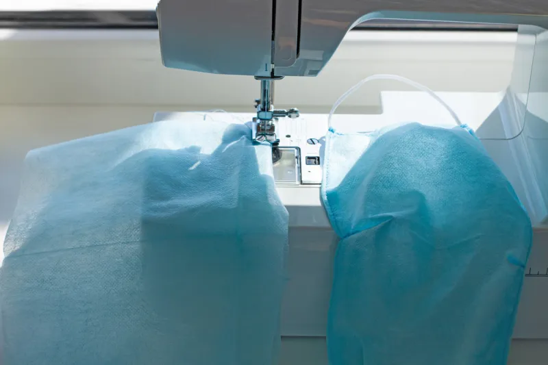 handmade sew the face mask against coronavirus disease covid-19 pandemia sewing machine with spunbond fabric, medical materials shortage remedies deficit,prevent dust,germs,homemade virus protection
