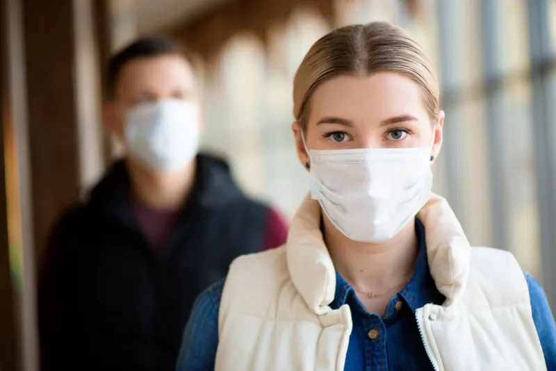 man and woman wearing protective mask against transmissible infectious diseases and as protection against the flu new coronavirus 2019-ncov from china