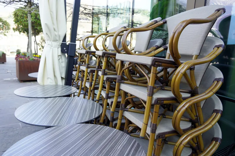 seats on a side, a restaurant closed, no operation because of coronavirus in north italian city of merano, italy