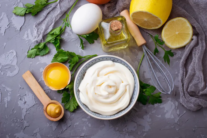 homemade mayonnaise sauce and olive oil, eggs, mustard, lemon selective focus