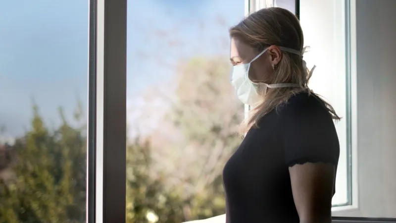 horizontal background of woman in isolation opening window taking fresh air against virus outbreak hypochondria