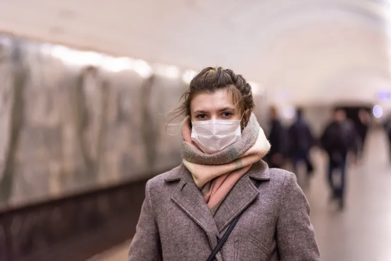 young attractive european caucasian woman in a protective mask protecting against influenza viruses and coronavirus covid-19 i in the subway