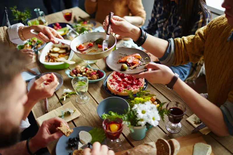 people sitting at dining table and eating