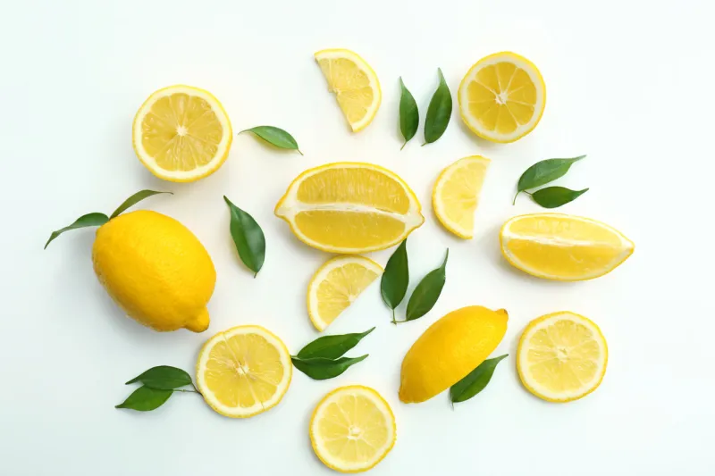 flat lay composition with ripe juicy lemons on white background