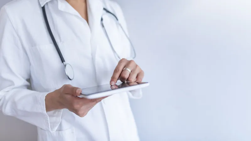 portrait of female doctor using her digital tablet in the office close-up of a female doctor using tablet pc a picture of a doctor holding tablet over white background
