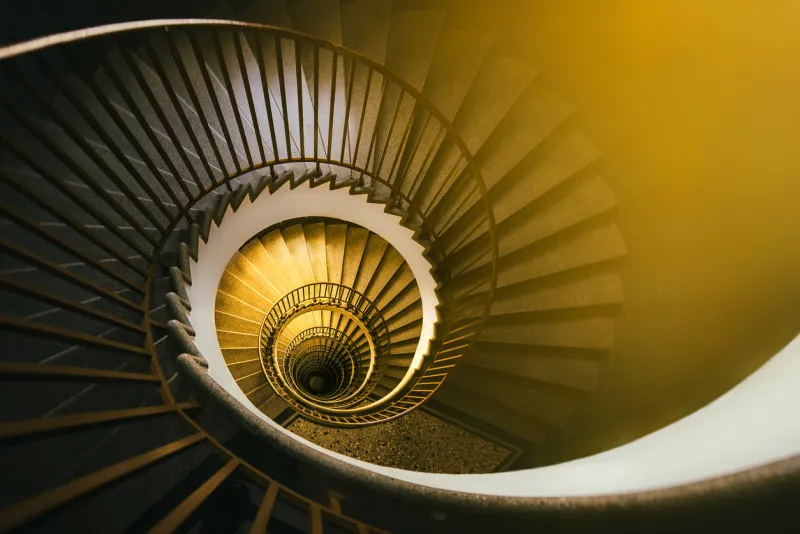 golden spiral staircase in an old building
