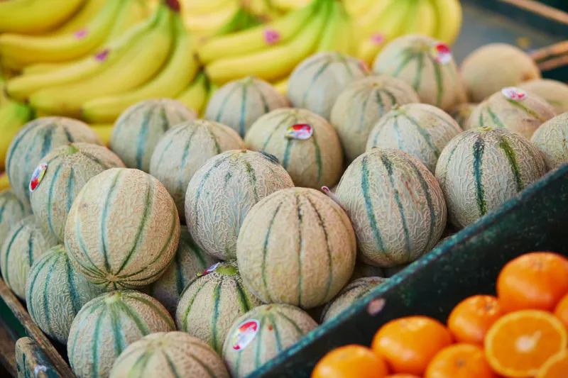 large heap of fresh ripe organic melons on farmer market in paris, france