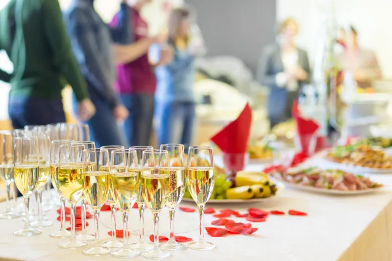 banquet event table with the wineglasses, snacks and cocktails