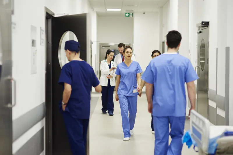 doctors walking through corridor in hospital