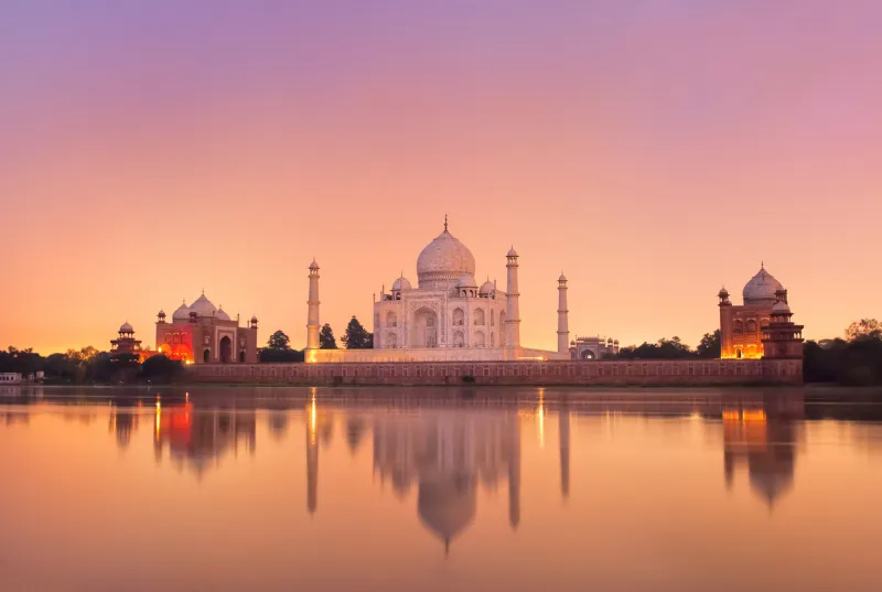 taj mahal reflecting in a river on sunset, agra, india