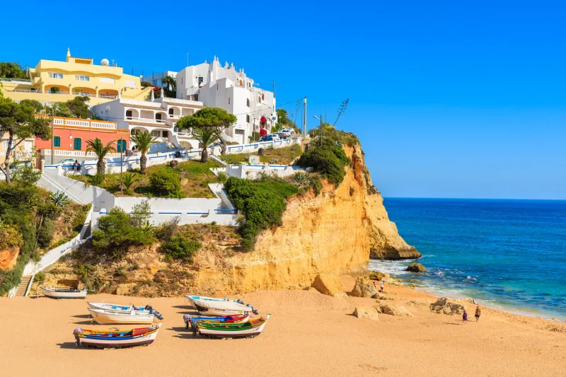 carvoeiro beach, portugal - may 11, 2015  typical fishing boats on beach in carvoeiro coastal village carvoeiro is popular holiday tourist destination on algarve coast