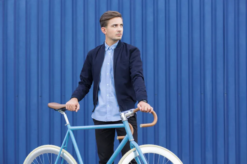 ecological young businessman with blue garage in background