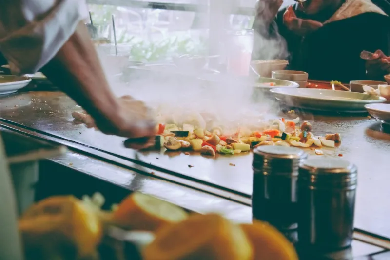 teppanyaki restaurant  chef cooking in front of guests
