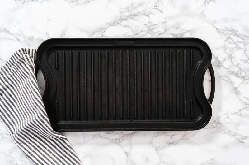 flat lay cast iron griddle on a marble background