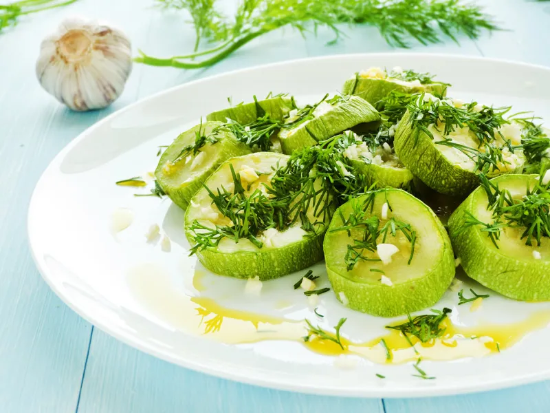 steamed zucchini with garlic, fennel and oil shallow dof