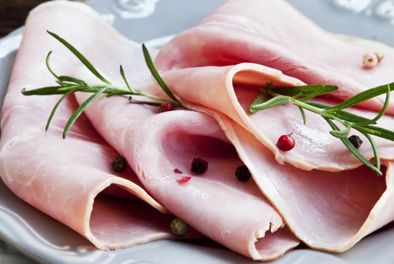 ham slices with rosemary and peppercorns, italian ham speciality