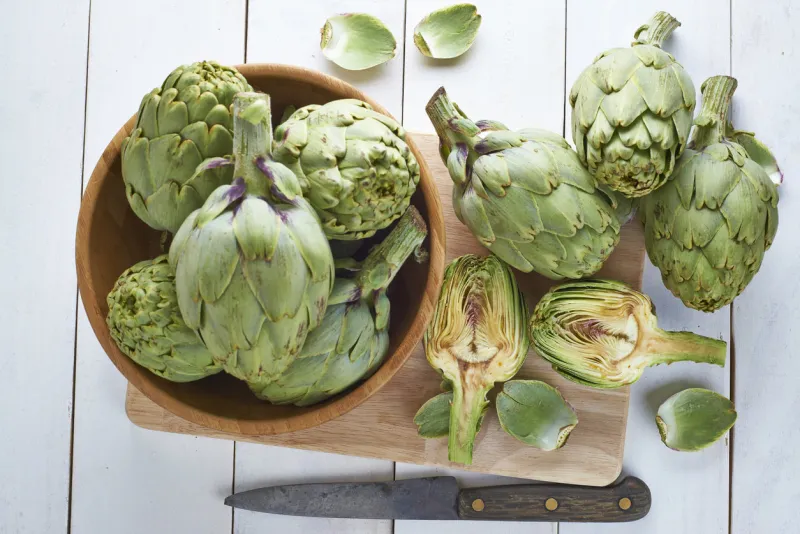 fresh artichokes on the table of the kitchen to be cooked