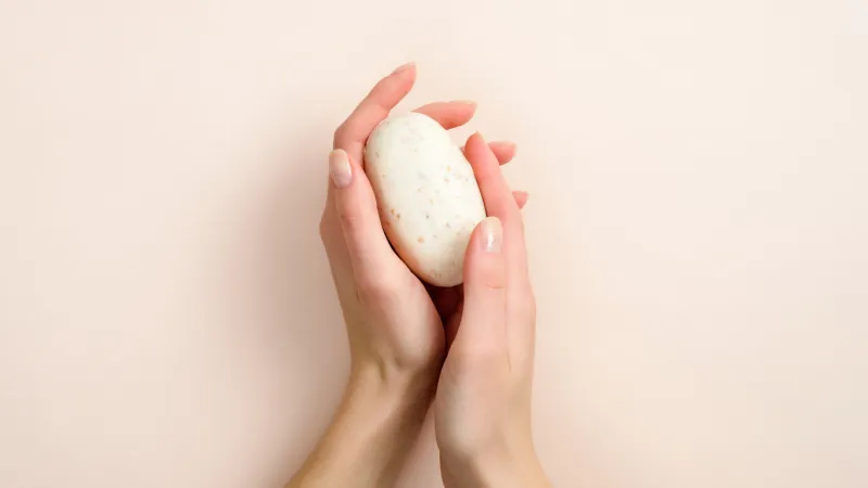 female hands holding natural organic soap healthy lifestyle, beauty, skin care zero waste, plastic free bathroom and home concept