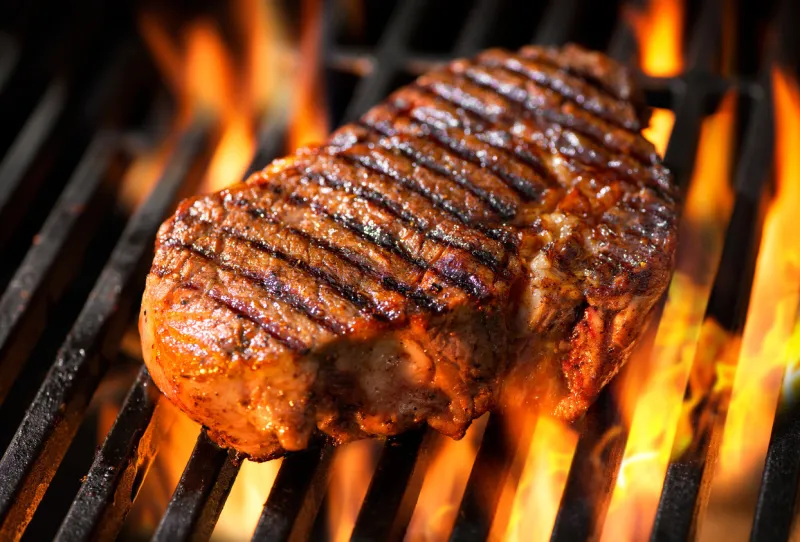 beef steak on the grill with flames