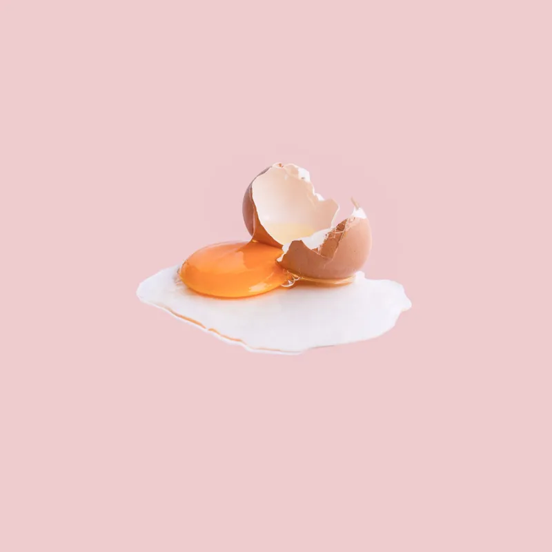 cracked egg on pastel backgrounds