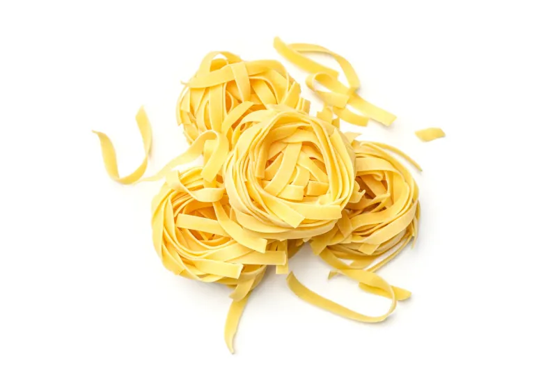 italian pasta fettuccine nest isolated on white background top view