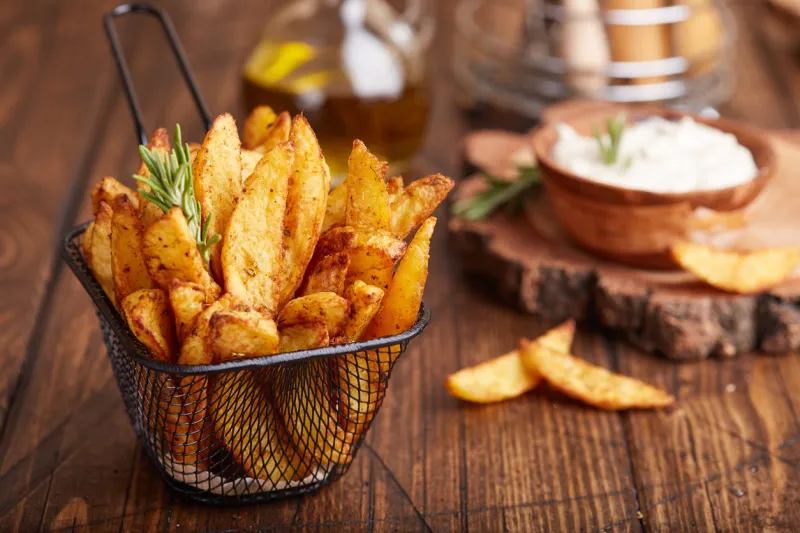 potato wedges baked with rosemary delicious snack served with sauce fast food