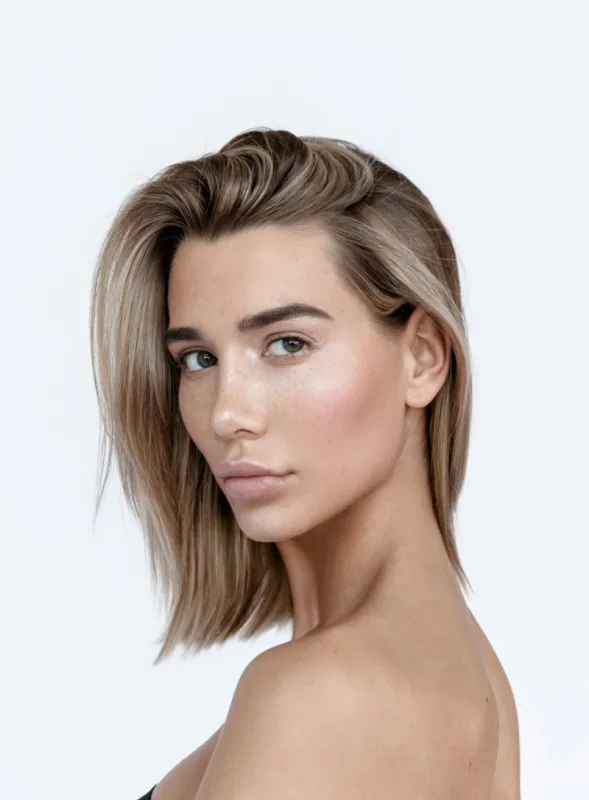 close-up portrait of young beautiful blonde woman with professional nude color make-up perfect foundation and pale lipstick looking fresh and lovely