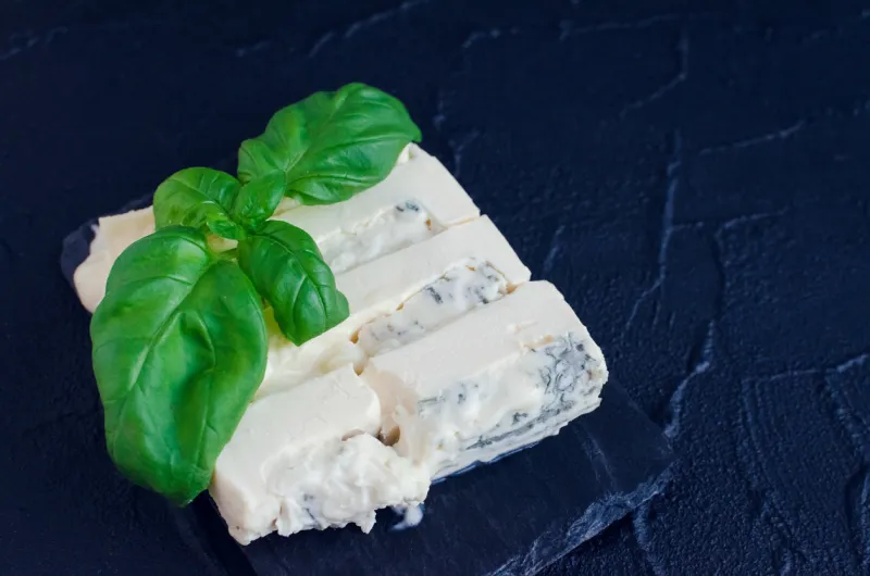 gorgonzola cheese with mascarpone with basil on slate plate on dark background with place for text tasty appetizers copy space