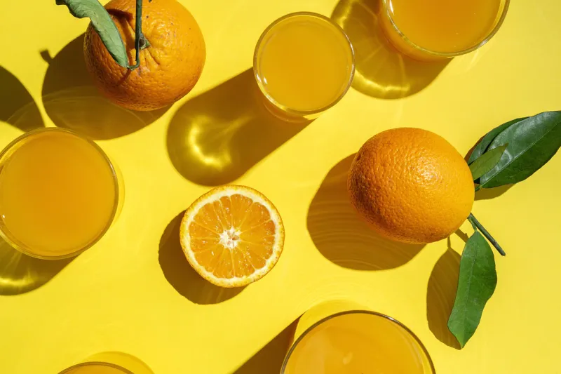 homemade orange juice from above on colored backgrounds with sunlightflat laytop viewhealthy drink