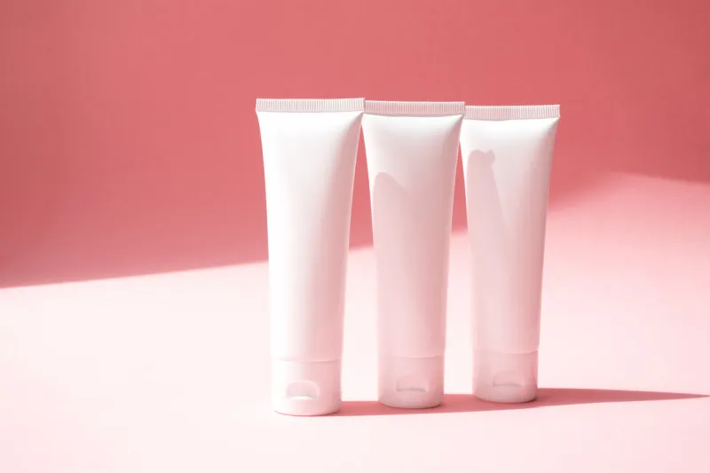 three moisturizer creams containers on cute pink background beauty product mockup with trendy shadow concept delicate, lightness and pure skincare