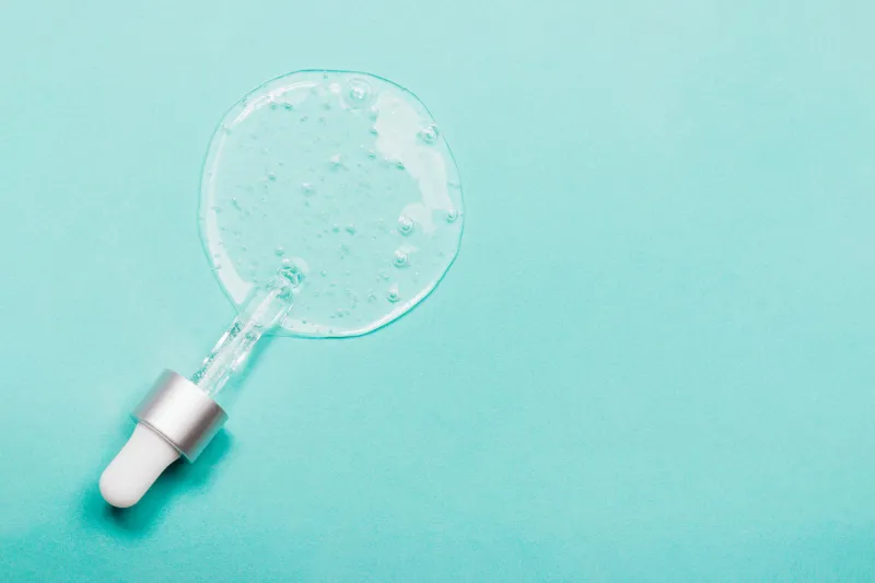 face serum close-up on the trendy mint background collagen, hyaluronic acid for skin care achievements of modern science in cosmetic to preserve beauty