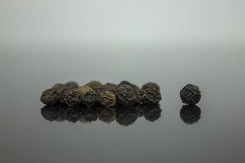 blackbpepper grains on wooden table