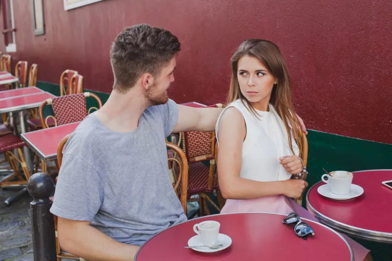 woman rejecting hugs of man, unhappy girl with annoying boyfriend