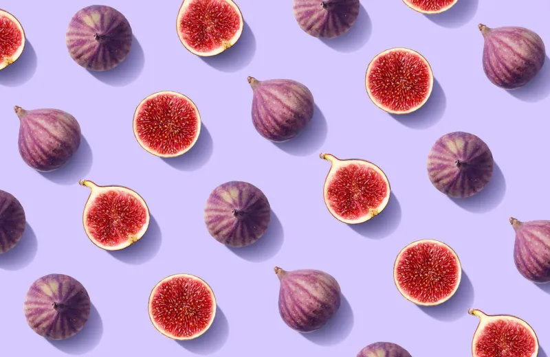 colorful fruit pattern of fresh figs on purple pastel background, top view, flat lay