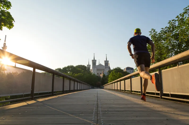 athlete running at notre-dame de fourviere in lyon on a beautiful summer morning lyon, france