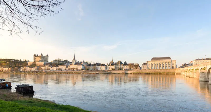 saumur, france - 17 feb 2019  skyline of the medieval town center with the castle and churches, along the loire river, in saumur, france