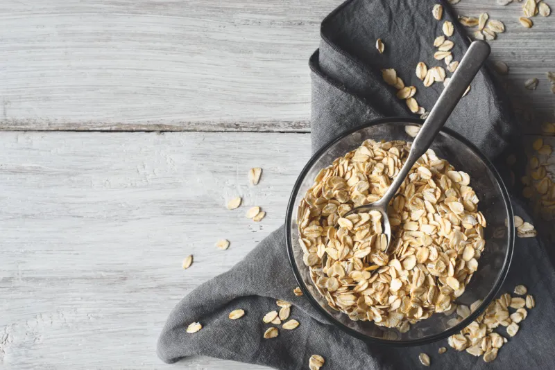 oat flakes in a glass bowl on a white wooden table
