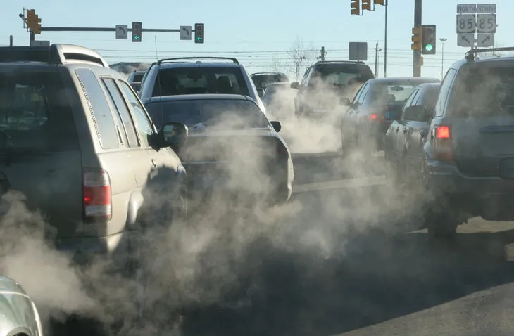 polluting clouds of exhaust fumes rise in the air