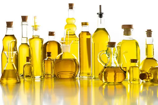 olive oil glass bottles arrangement in a row isolated on white background