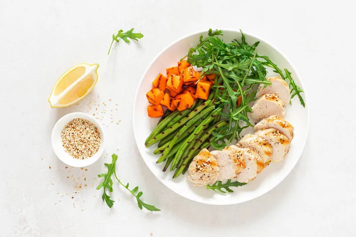 grilled chicken breast, fillet with butternut squash or pumpkin, green beans and fresh arugula salad, healthy food, top view