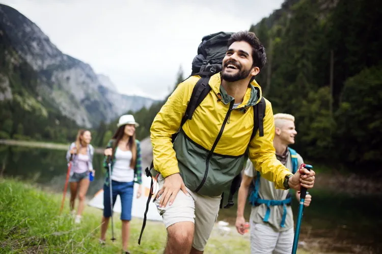 group of young friends hiking in countryside multiracial happy people travelling in nature