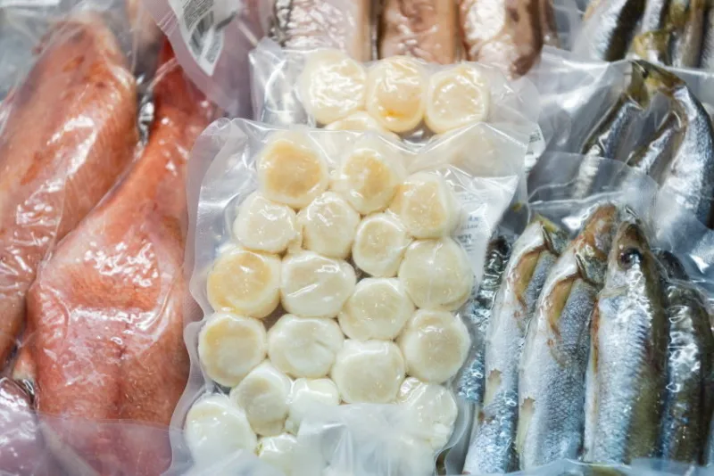 frozen fish in a commercial freezer different river fish, fish cakes, sea bass