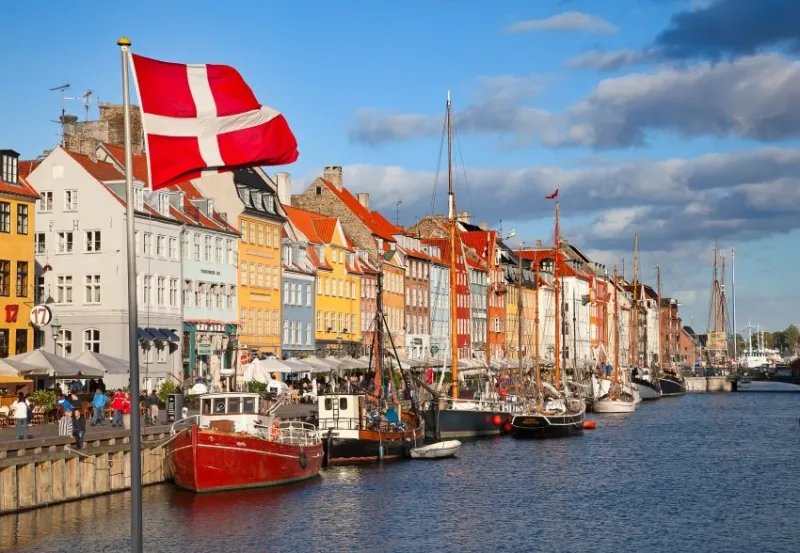 copenhagen, denmark - august 25  unidentified people enjoying sunny weather in open cafees of the famous nyhavn promenade on august 25, 2010 in copenhagen, denmark nyhavn district is one of the most famous landmark of copenhagen