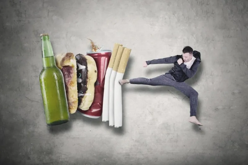 caucasian man wearing sportswear while fighting with cigarettes, beer and, fast food healthy lifestyle concept