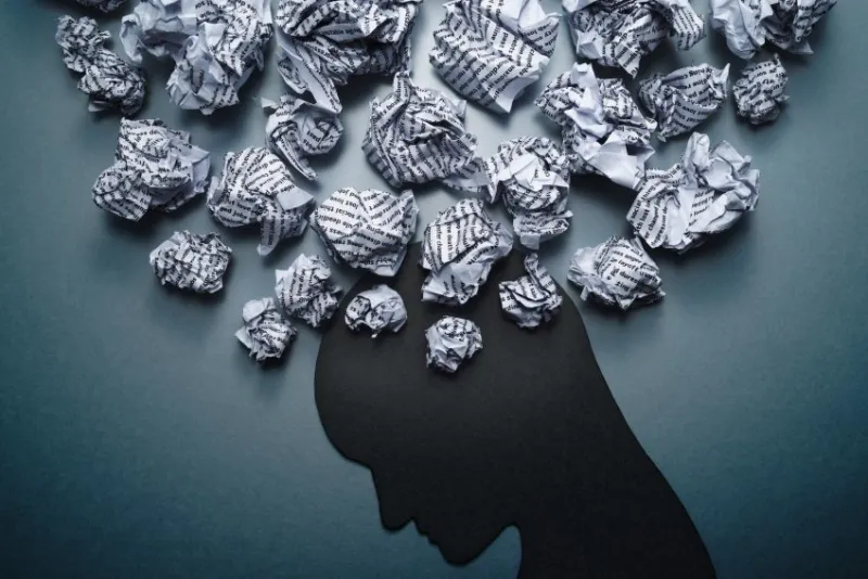 silhouette of depressed person head concept image of depression and anxiety waste paper and head silhouette