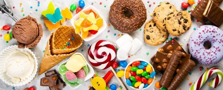 selection of colorful sweets - chocolate, donuts, cookies, lollipops, ice cream top view